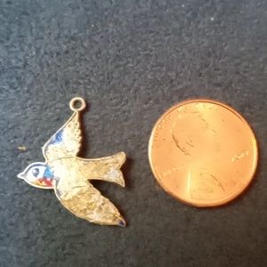 1" x 3/4" vintage silver bird charm with remnants of blue and red enamel.
